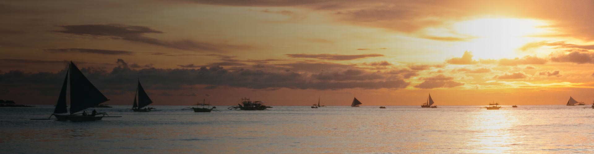 Båtar ute på havet vid solnedgång