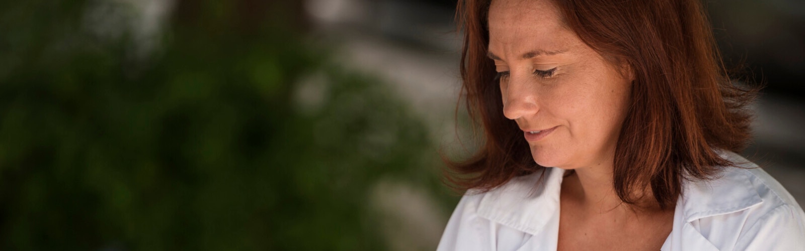 Photo of Eva, a healthcare professional. This article explores the differences between high and low-volume TAI.