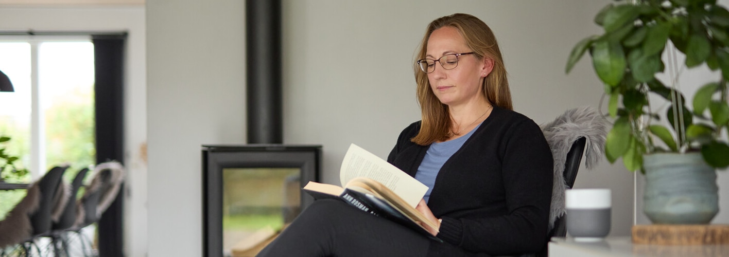 Carina, who uses low-volume TAI, sits in her living room. Peristeen light is a low-volume TAI system.